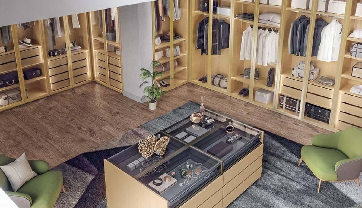 Walk-in closet amplio con isla central de cajones