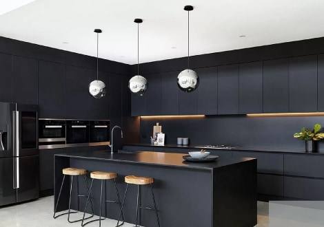 Cocina negra con isla y lámparas colgantes
